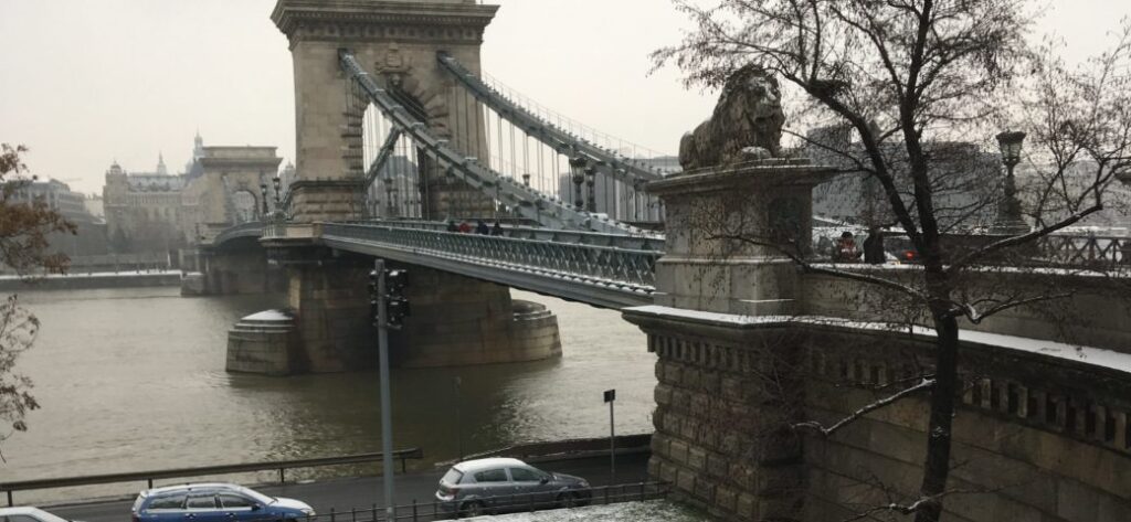 Bridge crossing the Danube on a snowy and grey day.