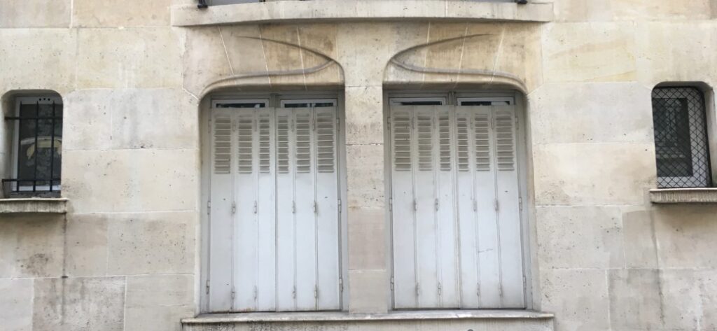 Art nouveau organic window design very well embedded in the building in Paris, France.