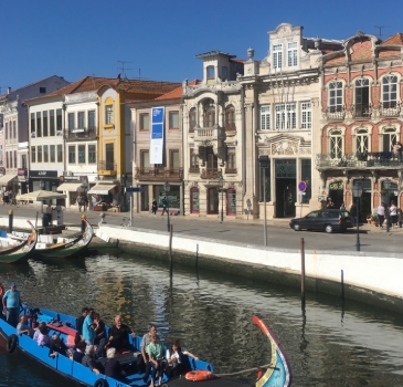 Art nouveau houses in Aveiro, Portugal, overlooking the river. Moliceiro Boat Tour on the Ria de Aveiro