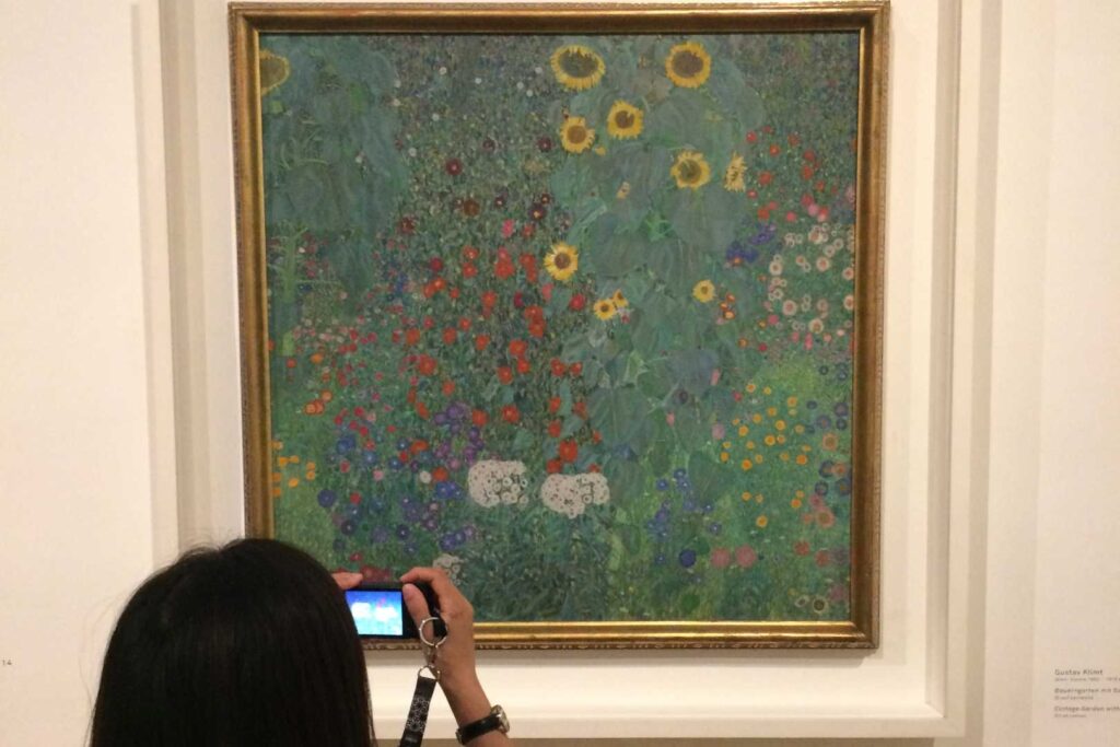 A woman picturing a Gustav Klimt amazing paining. In Vienna.