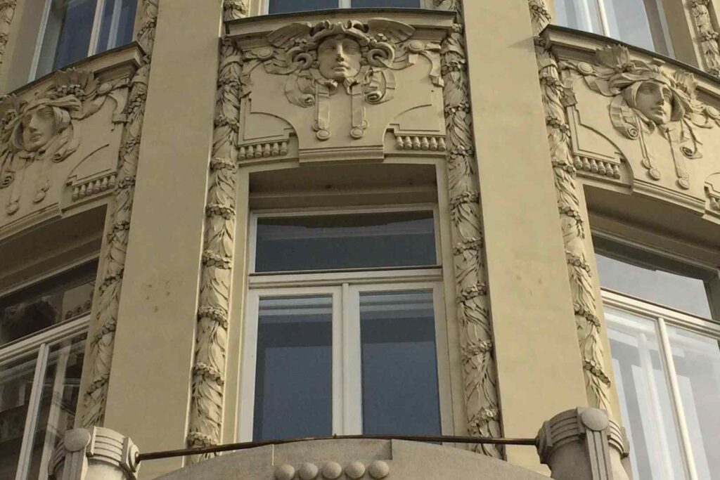 Detail of a building facade. Art Nouveau in Prague is pompous yet modest, joyful yet strict. You can find the imposing colorful facades and traditional Secessionist patterns. After years of being a part of the Austro-Hungarian Empire, Prague took all the best of its architectural thought and uniquely implemented the knowledge.